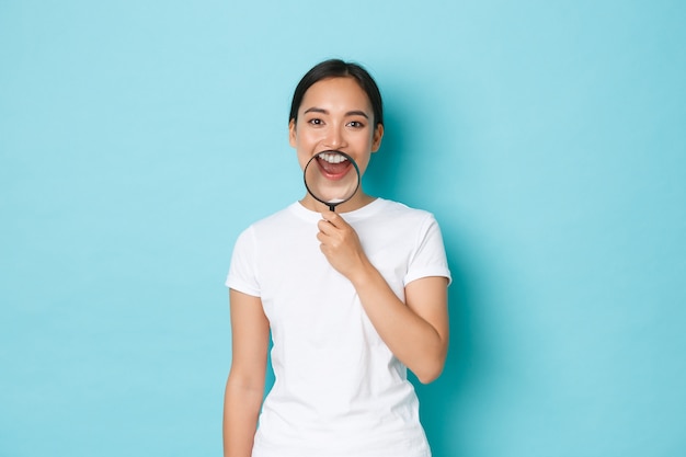 Young Asian woman wearing casual T-shirt posing